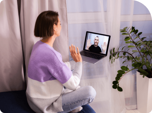 a woman sitting in front of a laptop