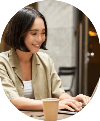 a woman smiling at a computer