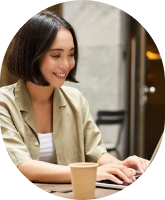 a woman smiling at a computer